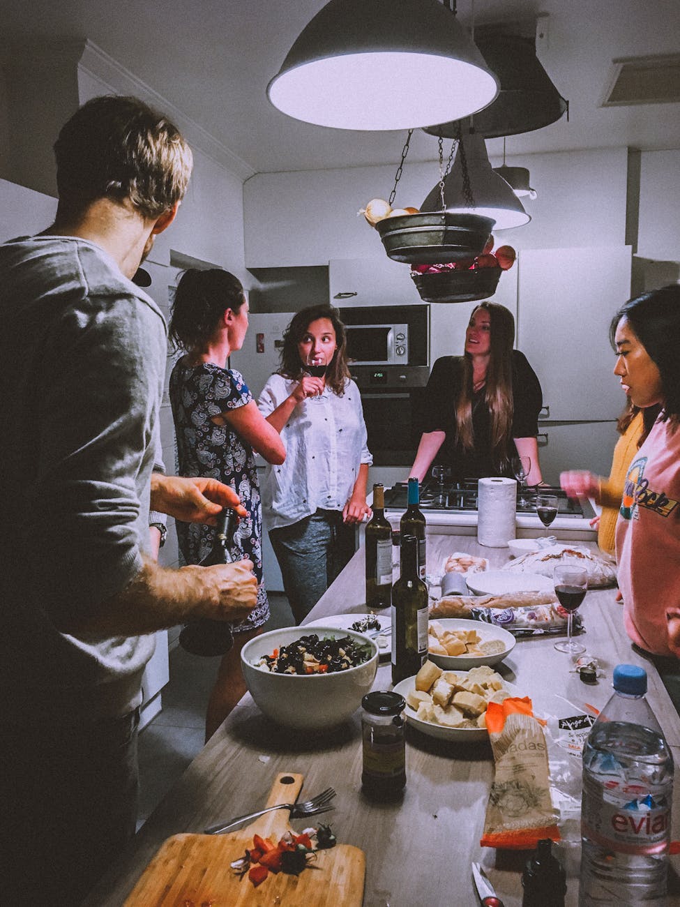 men and women standing infront of dining table